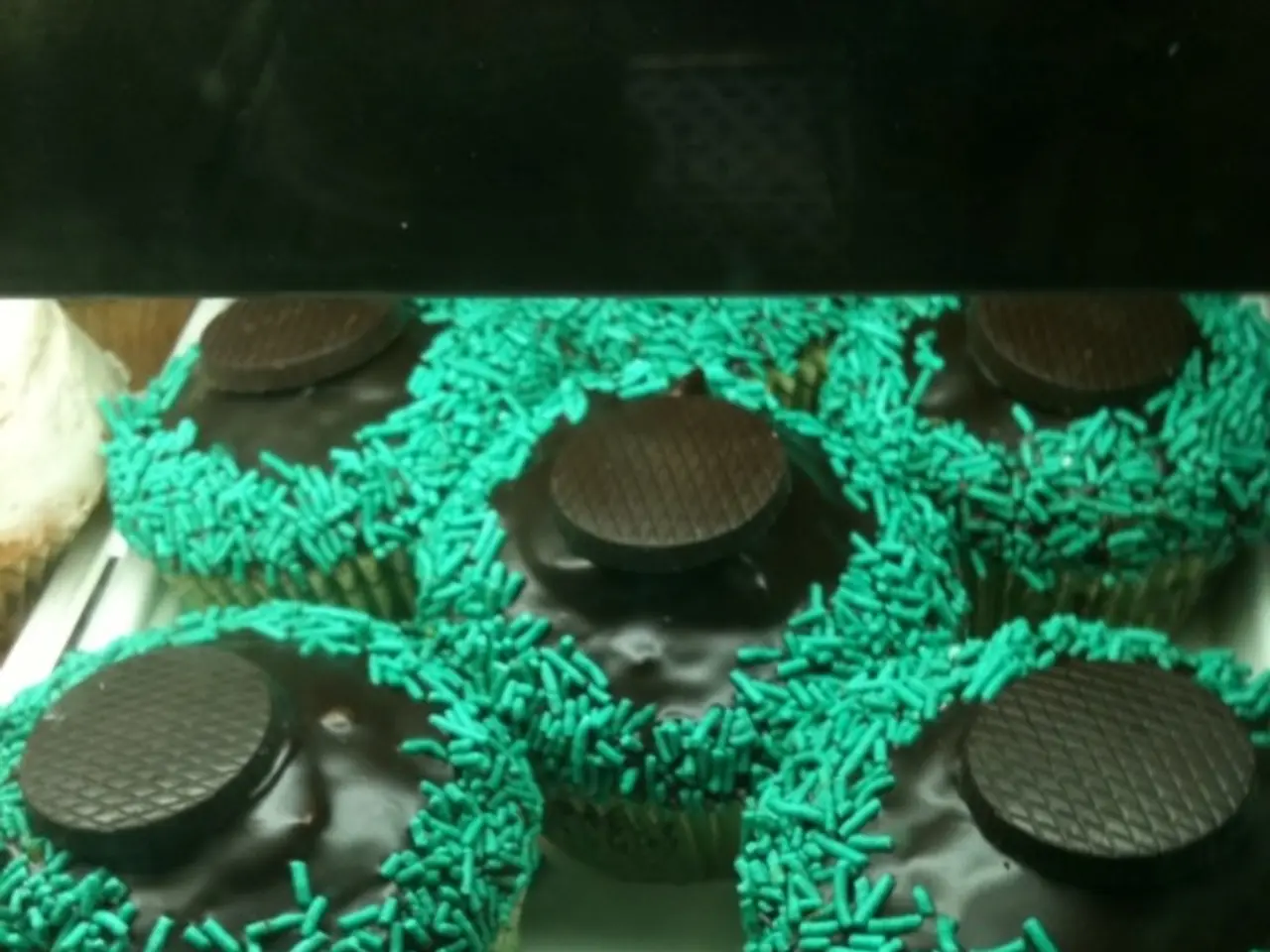 In the picture I can see the cupcakes in the serving plate and I can see the serving plate is kept...