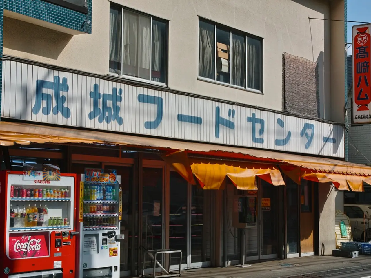 In this image I can see few colorful bottles inside the machines. To the right I can see few...