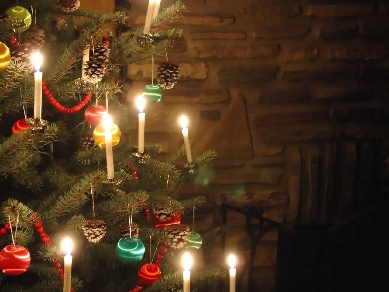 On the left side of the image there is a christmas tree with candles. In the background there is a...