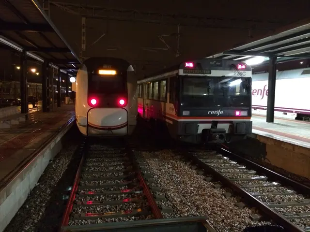 This is the picture of a railway station. In this image there are two trains on the railway track....