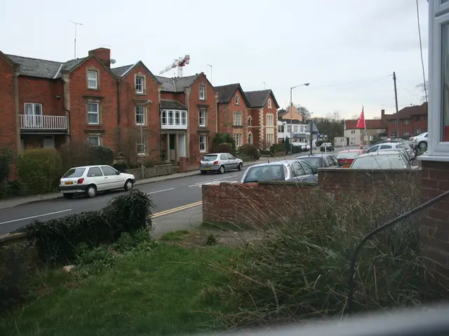 This image is clicked on the road. There are many cars parked on the road. In the middle, there is...