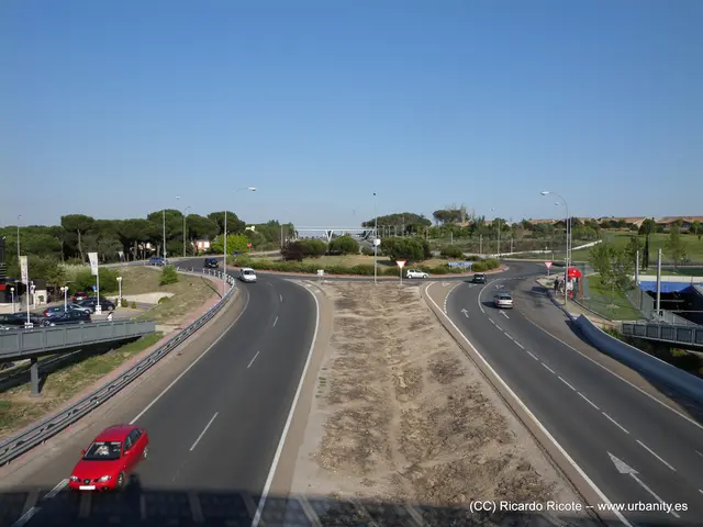 In this image I see the road on which there are number of vehicles and I see number of poles and I...