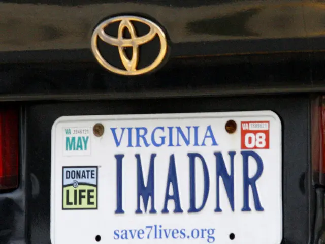 This is a picture of a logo of a vehicle and a name plate with numbers and words on it , which are...