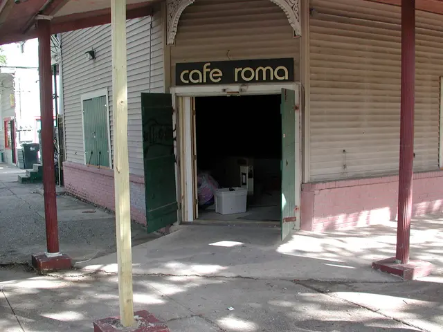 In this image I can see few buildings,windows,doors,stairs,dustbins,poles and few objects inside...