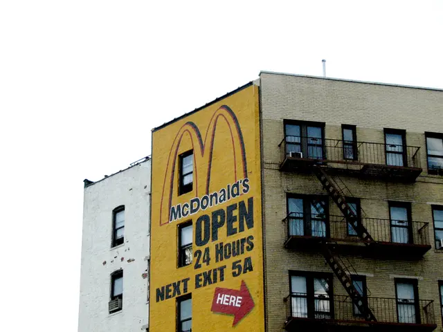 In this picture there is a building and there is a text on the building and there is a painting on...