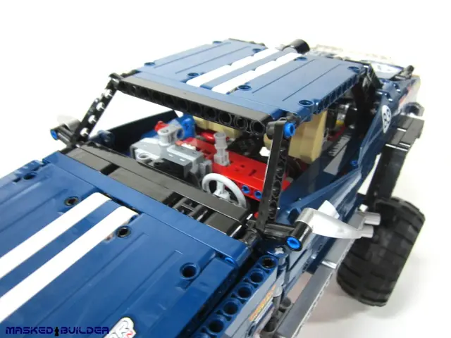 In this image I can see a toy car in blue color.