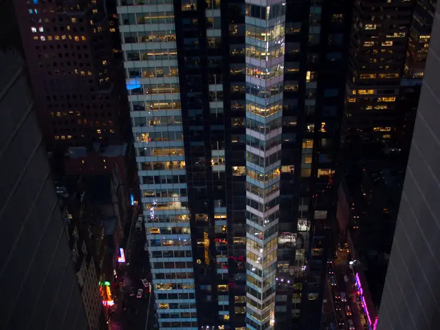 In this image I can see there are very big buildings with the lights.