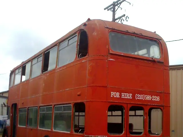 In this picture we can see red color double Decker bus is parked in the front. Behind there is a...